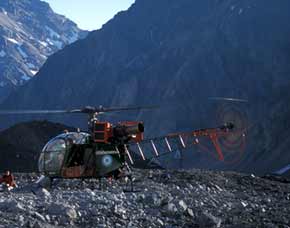 Argentine helicopter carries Dick Jessor to lower altitude.
