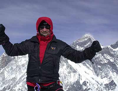 Dave Burger on summit with Everest behind