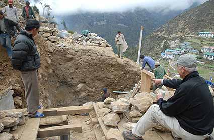 Doc sits for an hour and a half watching the construction of Anu’s new lodge