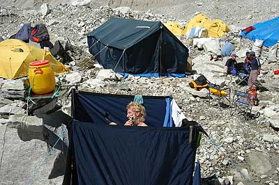 The luxuries of Base Camp: David Burger in the shower tent at B.C. He is shaving using the mirror on his Tates Compass. 