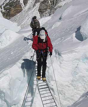 David Burger crosses a crevasse in the icefall, Garry Porter waits for his turn