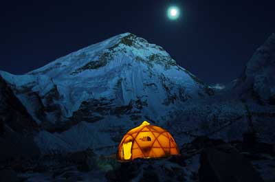 Moon rises over west shoulder of Everest and the BAI communications tent. Copyright Wally Berg 2003.