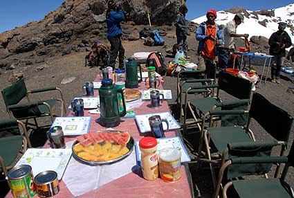 Tables set up right at Stella Point with plenty of food including fresh sliced watermelon, a remarkable morning at 19,000 feet
