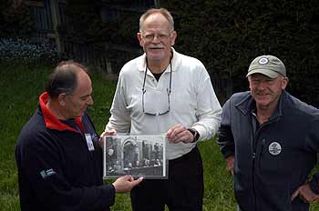 Woodie, Martin and Peter looking at Woodie's graduation