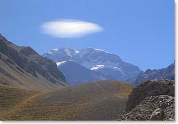 A lone lenticular cloud floats over Aconcagua. Lenticular clouds are stationary clouds that form at high altitudes. These clouds have often been mistaken for UFOs because of their smooth saucer-like shape