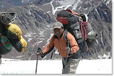 BAI guide Oswaldo carries a load to the higher camps