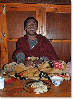 A monk roars in laughter after a long day of chanting