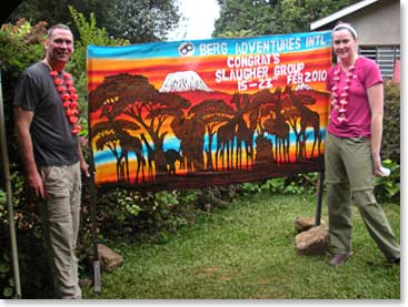 The Slaughters stand proudly with their banner for being the first group to climb the new Berg Adventures Pofu Route.