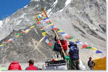 The flag goes up! Near the end of the pooja ceremony our prayer flag pole is raised over our chorten. The chorten will stand as the center of our base camp throughout the expedition.