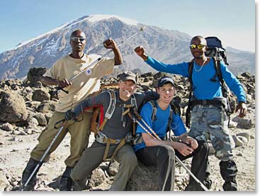 The successful team takes one more shot in front of Kilimanjaro’s summit.