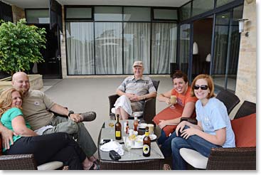 The family sits together on the veranda of the hotel.