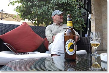 Catching up at the hotel with a Tanzanian staple, Tusker Beer.
