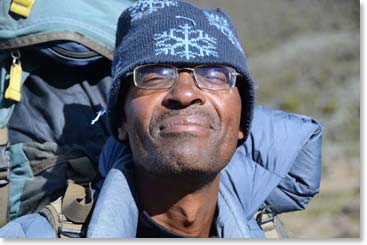 Berg Adventures chief Tanzanian Guide, John Mtui, stops to soak up some sun at the bottom of the wall.
