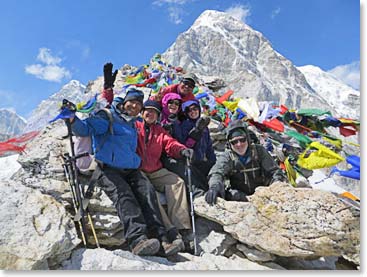 The team on the very top, holding on in the wind.  Pumori, nearly 23,000 feet high rises behind.