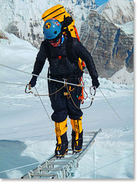 Daniel crosses a ladder above Camp I