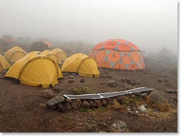 Our sun did not last long today. So we took a cozy “acclimatization day” in our tents. Dick’ solar charging panels can be seen in this photo. The amazing thing is they worked!