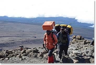 Arnold and Andrew on the way to the summit.  Arnold always carries our medical box – even to the very top of Kili!