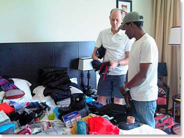 Climbers organizing and packing for the mountain with advice from their guides