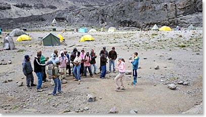 The team dancing and singing at Moir Camp