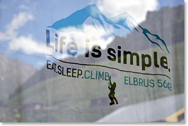 Our life in the Elbrus Region is simpler now. Sign on tee shirt in a shop window: “life is simple: eat, sleep, climb Elbrus”