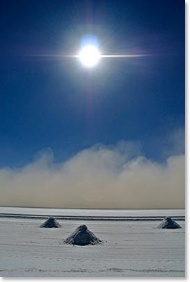 Salar de Uyuni is the world’s largest salt flat. A prehistoric lake that went dry leaving behind a landscape of bright white salt, rock formations and cacti islands. On this image you can see the wind storm approaching our team.