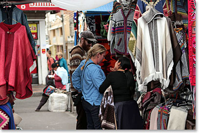 Kim and Mike doing business with the saleswoman at the market