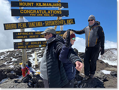 Jackson, Jim and Ryan check the plaque on top of Kilimanjaro