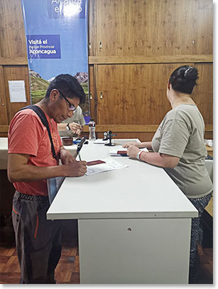 At the Park Headquarters to get our permits, Sergio is completing his form.